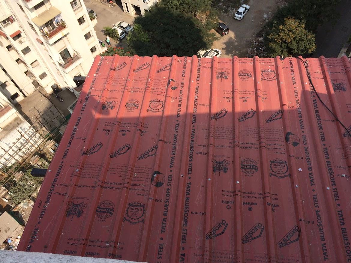 A compact balcony roofing shed providing protection from rain and sun.